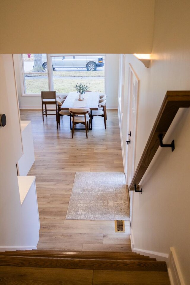 stairway with baseboards and wood finished floors