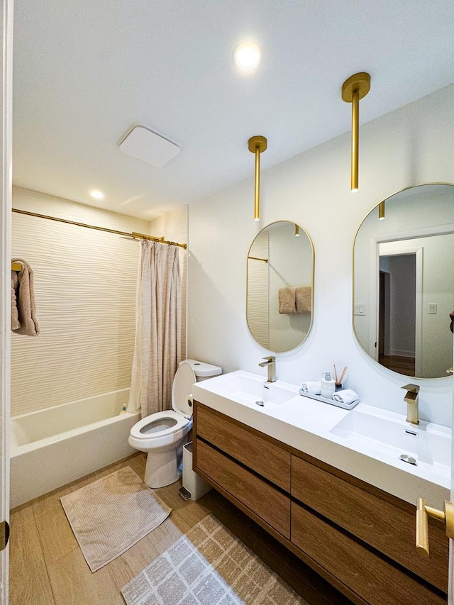 full bathroom with toilet, shower / bathtub combination with curtain, double vanity, and a sink