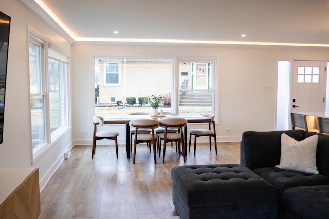 dining space featuring recessed lighting, baseboards, and light wood finished floors