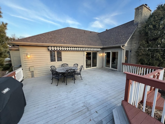 deck featuring grilling area and outdoor dining space