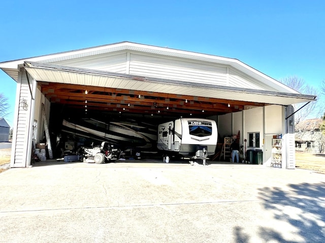 garage featuring concrete driveway