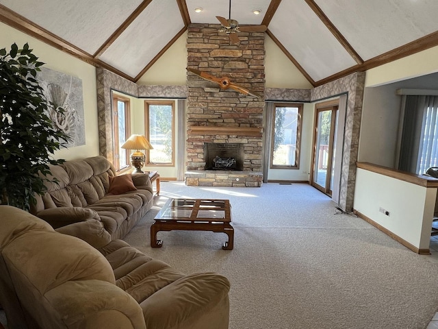 carpeted living area featuring a stone fireplace, a ceiling fan, baseboards, and high vaulted ceiling