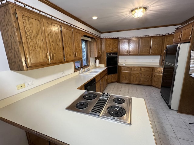 kitchen with crown molding, light countertops, brown cabinets, black appliances, and a sink