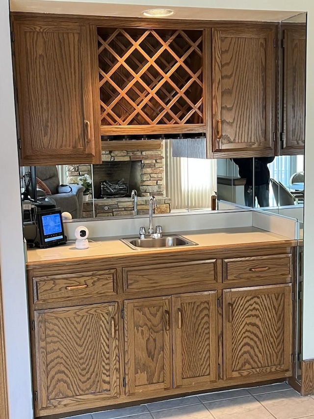 kitchen featuring a sink, light tile patterned floors, and light countertops