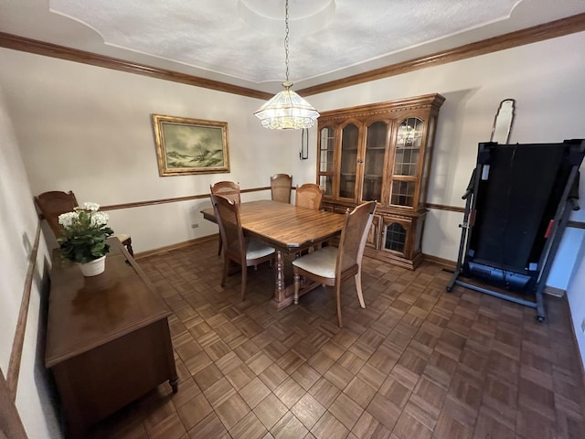 dining space featuring baseboards, an inviting chandelier, and ornamental molding