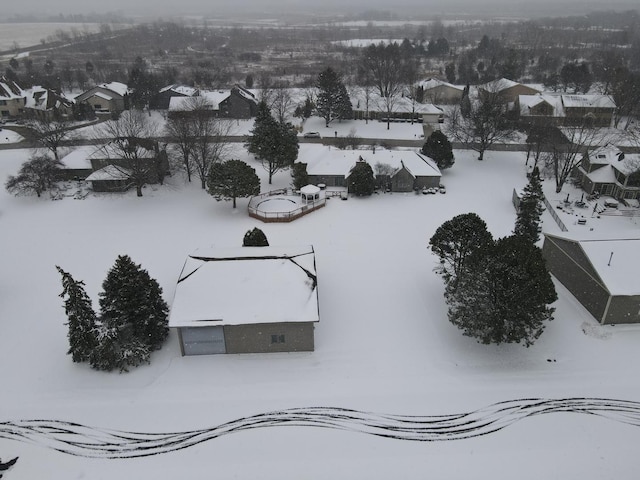 snowy aerial view featuring a residential view