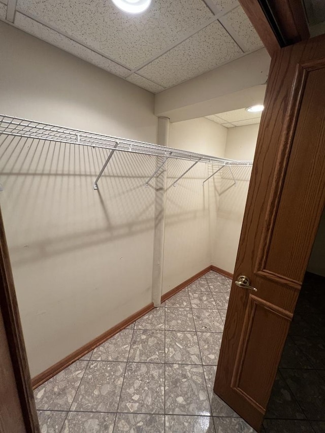 spacious closet with a drop ceiling