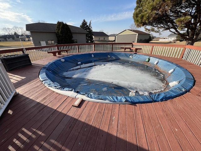 view of swimming pool with a hot tub