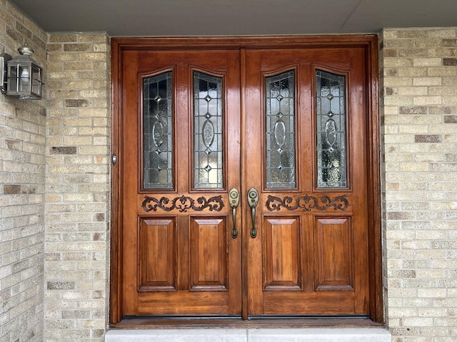 property entrance featuring brick siding