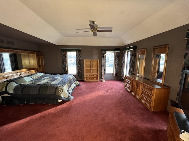 bedroom with visible vents, a ceiling fan, lofted ceiling, and carpet floors