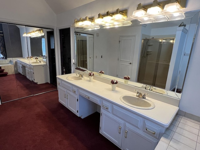 full bathroom with vaulted ceiling, a shower stall, and a sink