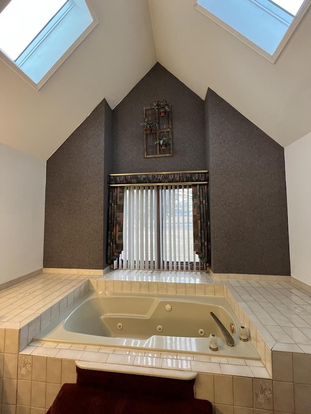 bathroom featuring lofted ceiling with skylight and a jetted tub