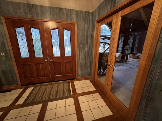 entrance foyer featuring tile patterned flooring, french doors, and baseboards