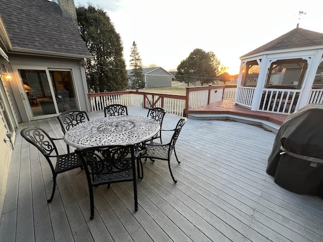 deck featuring outdoor dining space, a gazebo, and area for grilling