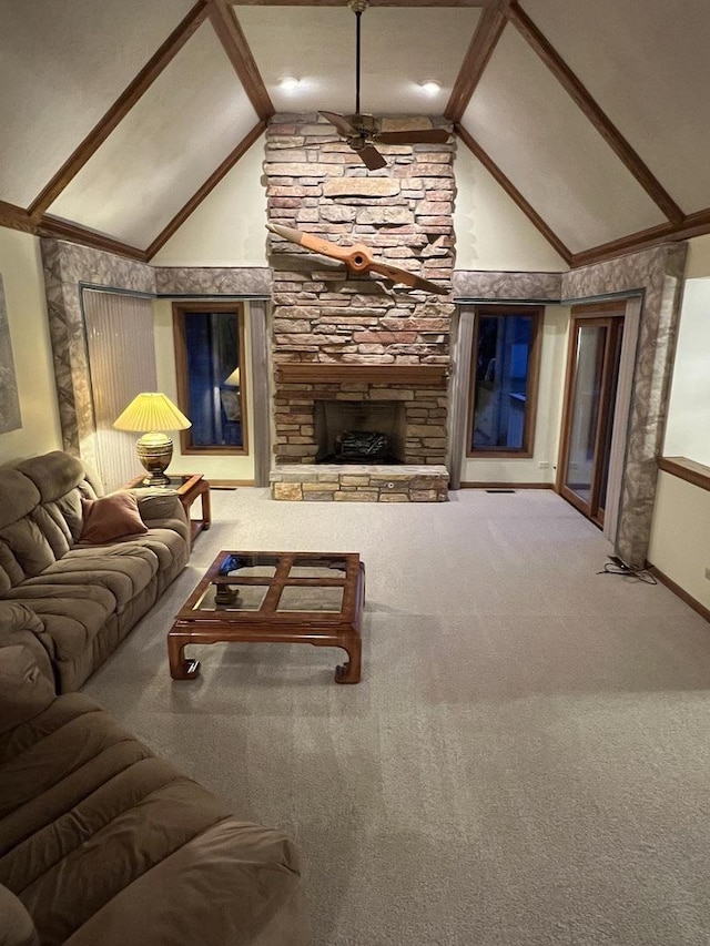 carpeted living area with beam ceiling, high vaulted ceiling, a stone fireplace, and a ceiling fan