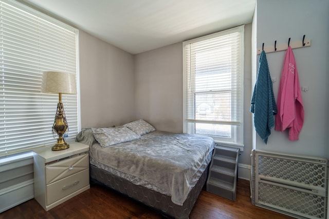 bedroom featuring dark wood finished floors