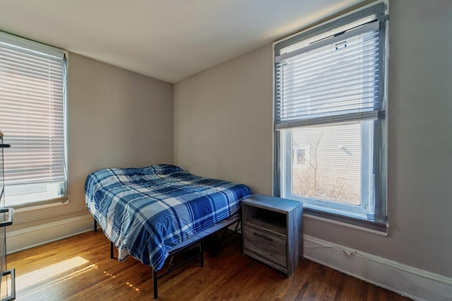 bedroom with baseboards and wood finished floors