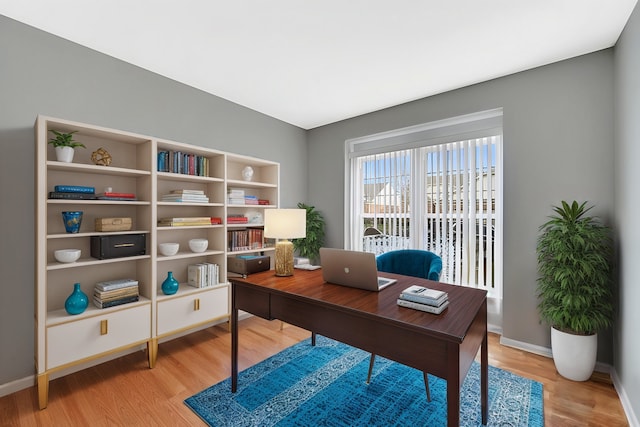 home office with light wood finished floors and baseboards