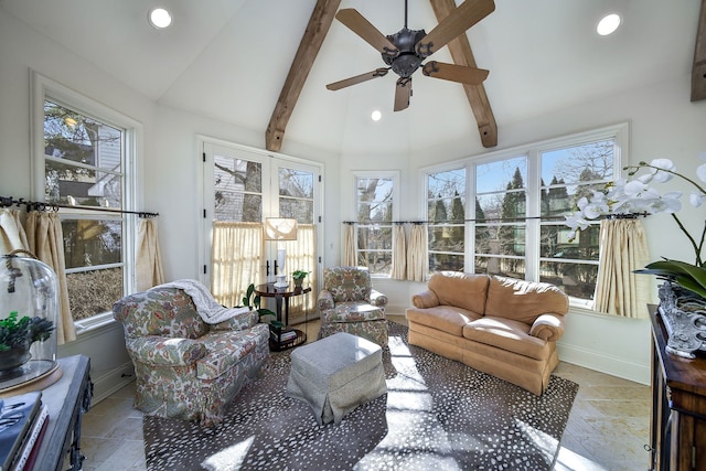 sunroom / solarium with lofted ceiling with beams, a wealth of natural light, and a ceiling fan