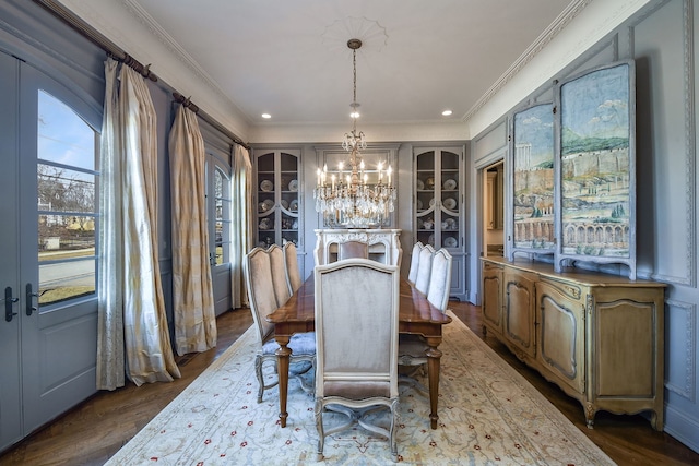 dining area featuring dark wood finished floors, an inviting chandelier, recessed lighting, and ornamental molding