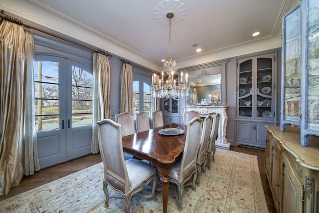 dining space with dark wood finished floors, recessed lighting, french doors, and ornamental molding