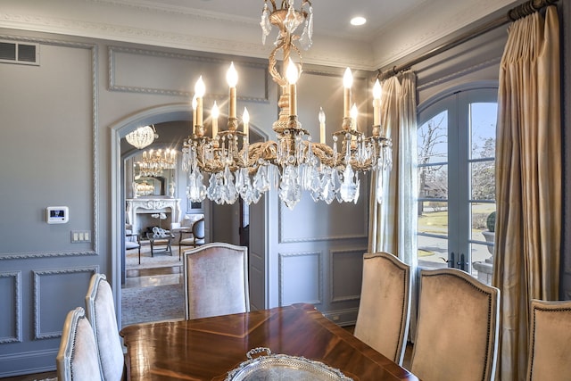 dining area featuring arched walkways, visible vents, french doors, and a decorative wall