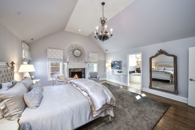 bedroom featuring wood finished floors, baseboards, lofted ceiling, a fireplace, and a notable chandelier