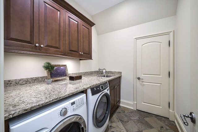 washroom featuring washer and clothes dryer, cabinet space, baseboards, and a sink