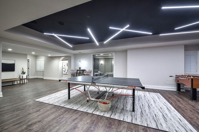 recreation room featuring baseboards and wood finished floors