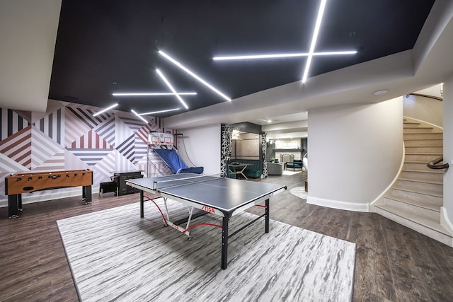 recreation room with baseboards and wood finished floors