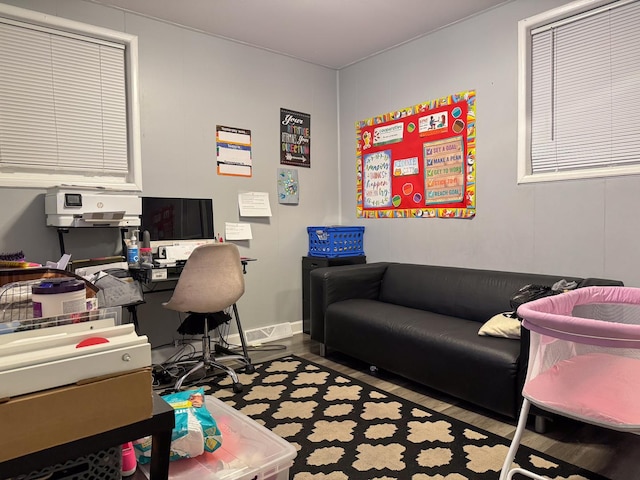 office area with baseboards and wood finished floors