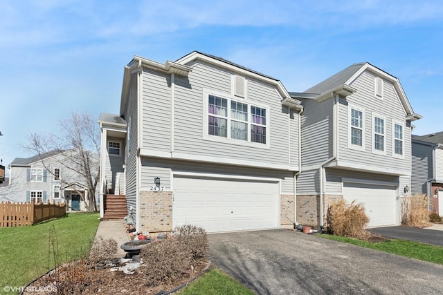 view of front of property featuring aphalt driveway, an attached garage, and fence