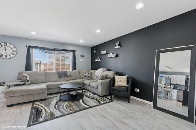 living area featuring light wood finished floors, recessed lighting, and baseboards