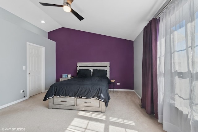 carpeted bedroom with baseboards, lofted ceiling, and a ceiling fan