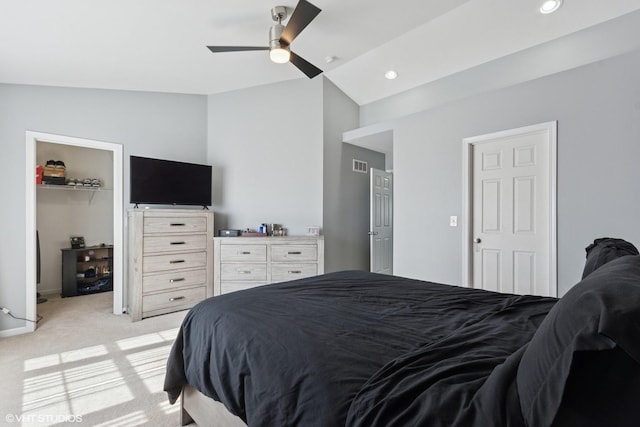 bedroom featuring visible vents, recessed lighting, vaulted ceiling, a spacious closet, and light colored carpet