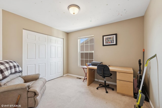 home office featuring visible vents, baseboards, and light carpet