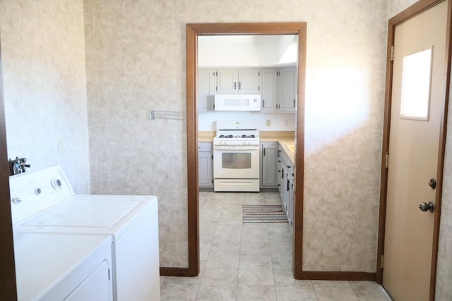 laundry room with laundry area, light tile patterned flooring, and separate washer and dryer