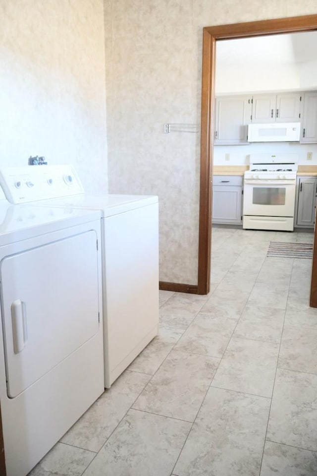 washroom featuring laundry area and washing machine and dryer