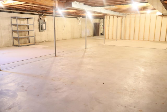 unfinished basement featuring electric panel