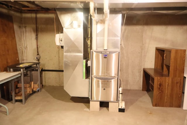 unfinished basement featuring heating unit