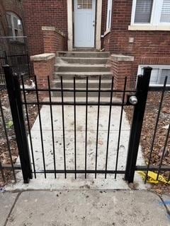 view of gate featuring fence and entry steps