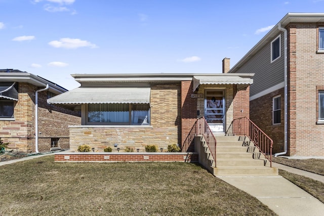 view of front of home with stone siding, brick siding, and a front lawn