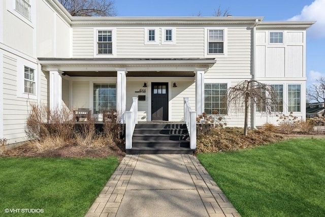 view of front of property with a porch and a front yard