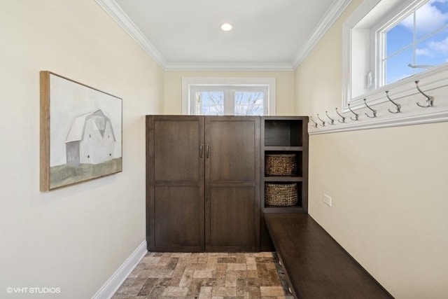 mudroom featuring crown molding and baseboards