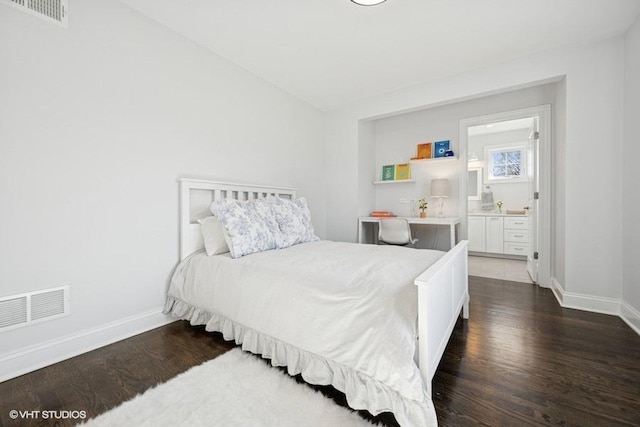 bedroom featuring visible vents, baseboards, and dark wood-style floors