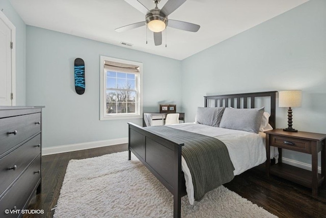 bedroom with visible vents, baseboards, dark wood-type flooring, and a ceiling fan