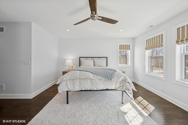 bedroom with visible vents, a ceiling fan, baseboards, and dark wood-style flooring