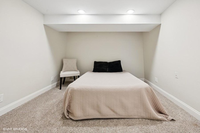 bedroom featuring carpet and baseboards