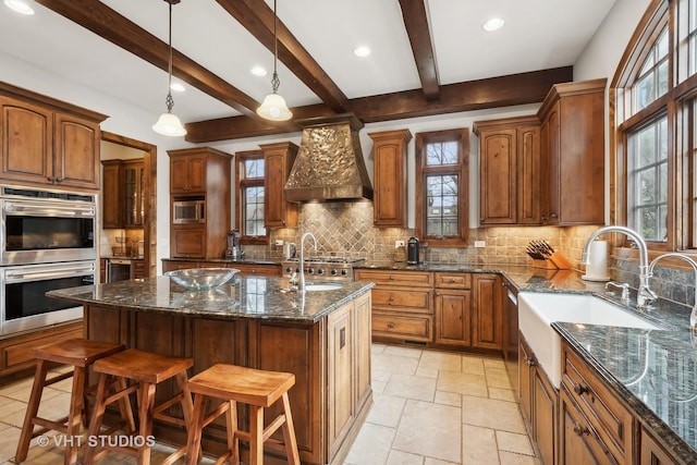 kitchen featuring a sink, stainless steel appliances, custom exhaust hood, and decorative backsplash