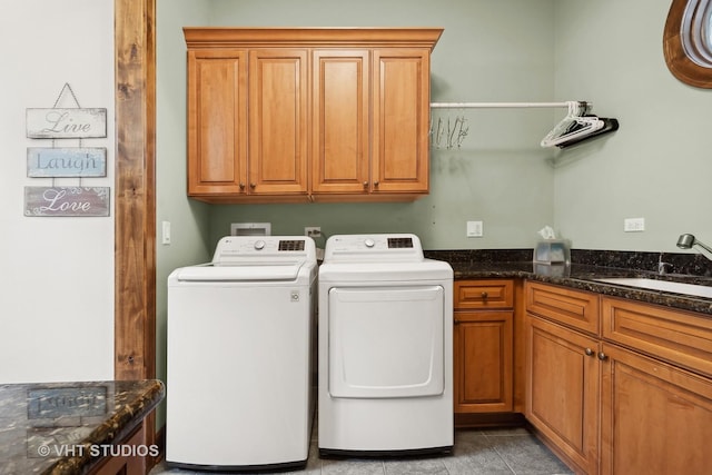 washroom featuring light tile patterned flooring, cabinet space, a sink, and separate washer and dryer